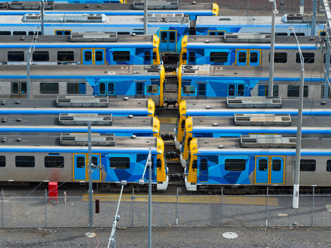 Commuter trains lined up in a city railyard