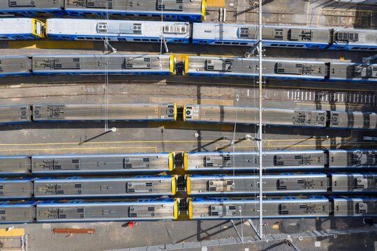 Commuter trains lined up in a city railyard