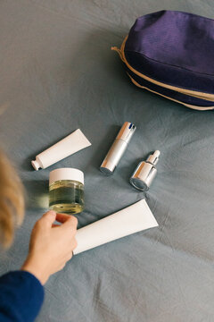 Anonymous woman organizing her skincare and beauty items