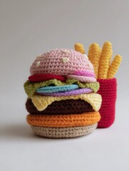 Crocheted burger and fries are next to each other