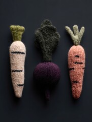Three knitted carrot and beet toys are displayed on a black background