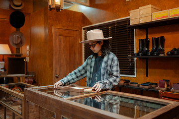Young man arranging merchandise in Japanese retail store