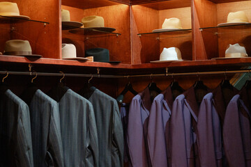 Vintage haberdashery showcase displaying men's hats and suits
