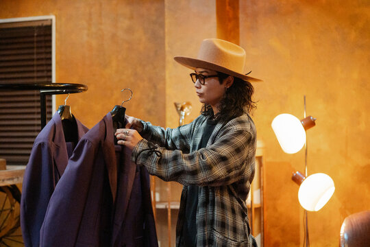 Stylish Japanese man working in fashion clothing store
