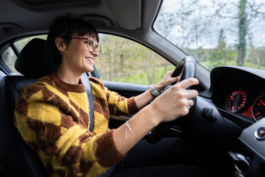 Woman driving car enjoying a happy road trip journey