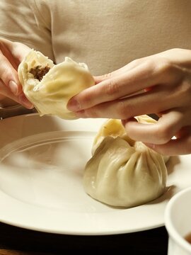 Woman eating traditional Buryat buuz dumplings