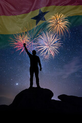 Man against background of a fireworks and national flag of Ghana