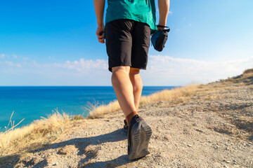 young man walking on the beachside