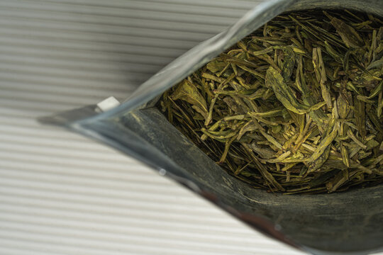 Dried green tea leaves in foil pouch