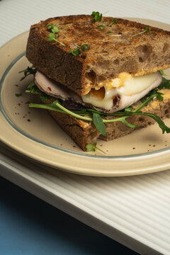 Grilled sandwich with melted cheese and greens