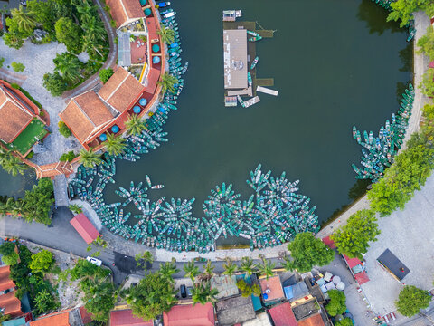 Tourist boats on a lake surrounded by a colorful township