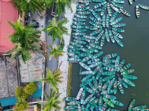 Tourist boats in tied up forming patterns around the edge of a lake