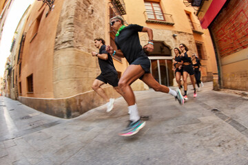 Running group enjoys morning exercise in lively city street