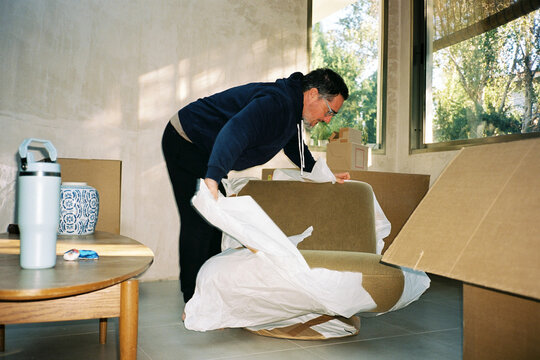 Man Unpacking New Armchair
- Powered by Adobe