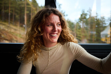 Happy woman sitting indoors