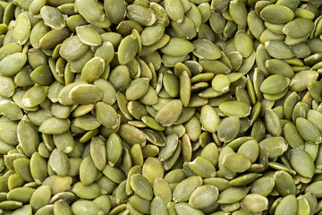 Green Pumpkin seeds isolated closeup photo.