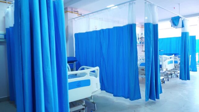 Video footage of an Indian hospital ward featuring standard medical beds and healthcare infrastructure. Suitable for medical, healthcare, insurance, and public health related content.