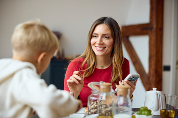 Mother and son are having breakfast
