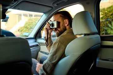 Man takes photos from a car