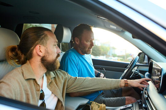 Two men drive in a car.