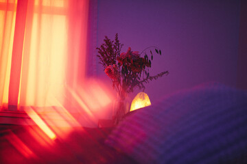 Moody Bedroom Interior With Flowers and Salt Lamp