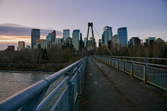 Pedestrian Bridge Leading Toward Calgary Downtown Skyline at Sunset