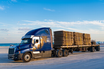 American style truck. Transport concept. Road freight cars. rucking with semitruck vehicle. Semi truck in America. Freightliner trailer transportation. Rig truck semi trailer hauling