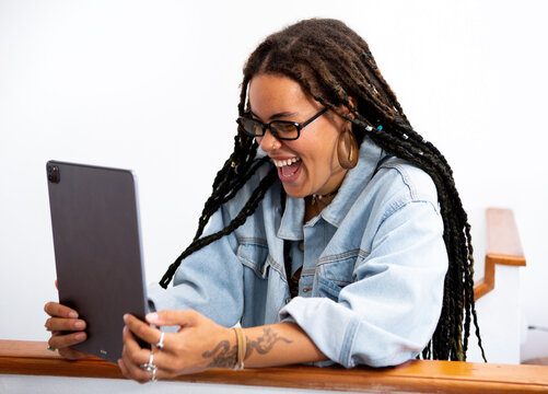 Excited Woman Enjoys Video Call on Tablet in Bright Indoor Space