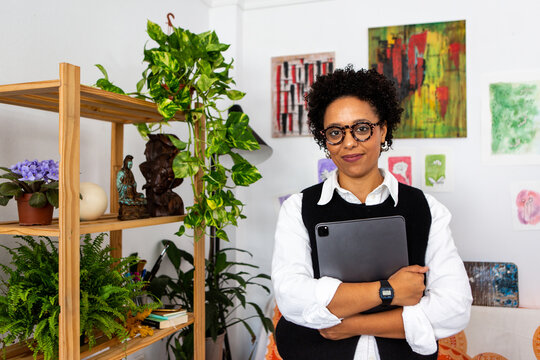 Woman With Tablet in a Cozy, Decorated Workspace