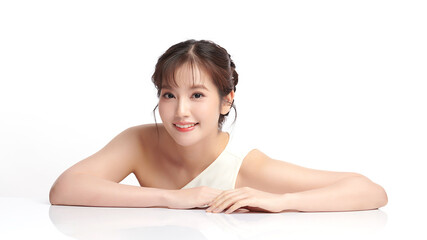 A beautiful young Asian woman with clean, fresh skin against a white background. Skincare, facial treatment, cosmetology, beauty, and spa. An elegant portrait of an Asian woman.
