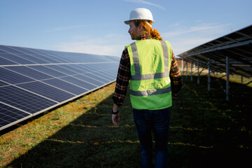 Engineer inspects solar panels in a renewable energy field