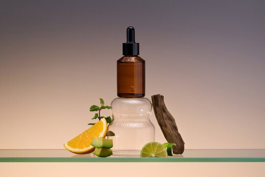 A stylish product with an amber dropper bottle and fruits, herbs