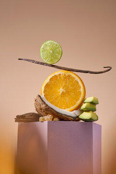 A balanced arrangement of fruits, including orange slices and vanilla