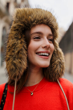 Woman smiling in fur ushanka hat in the city