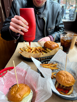Restaurant burgers on table with ketchup squeeze