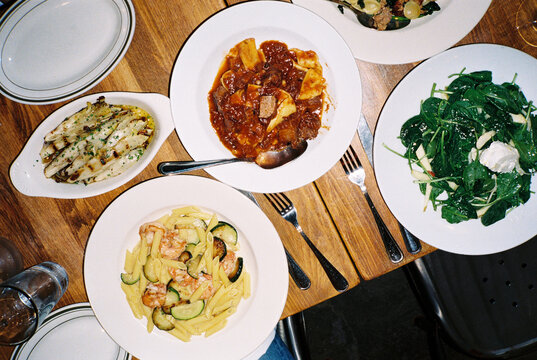 Plates of Italian Food on a Restaurant Table