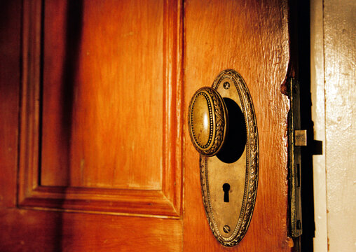 Architectural Detail of Antique Doorknob on Wooden Door