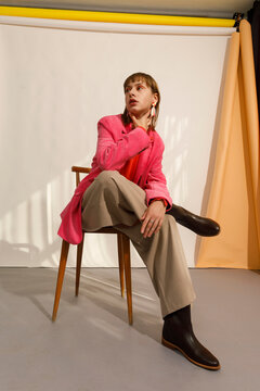 Stylish Model Poses in Pink Blazer and Brown Boots 