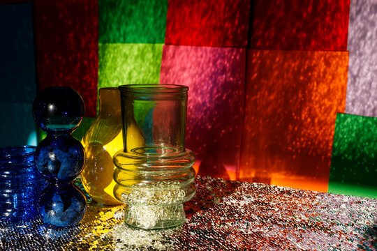 Brightly Colored Glass Objects on a Shiny Surface