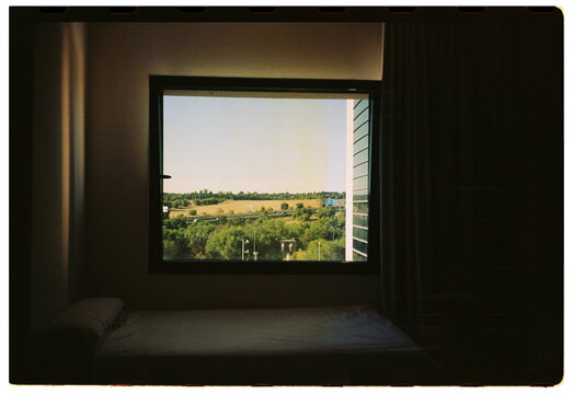 Minimal room interior with countryside view through window