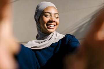 Muslim woman smiling for a joyous selfie portrait