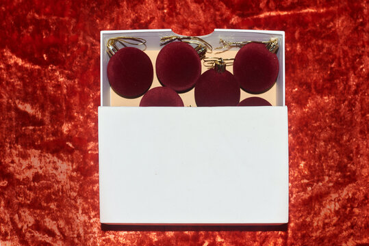 Velvet red Christmas ornaments in a white box 