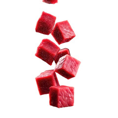 Cubed, bright red meat falling against a black backdrop