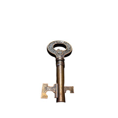 Bronze key with intricate details set against black