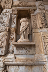 Fototapeta premium Headless statue of Episteme, goddess of knowledge, at the Library of Celsus, Ephesus, Turkey. Detailed ancient Roman architectural carvings.