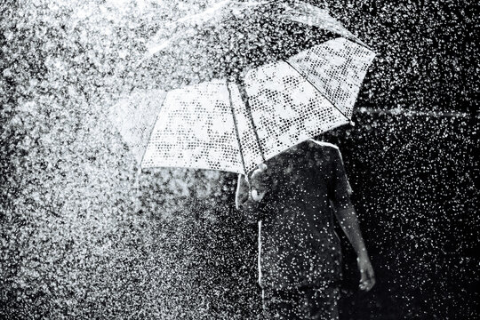 Walking in the rain with an umbrella on a gray day