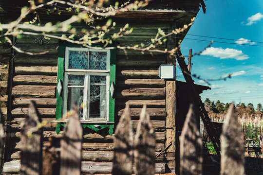 Rustic wooden house with green window frame