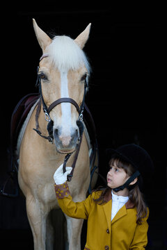Young girl holding reins 
