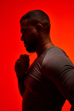 Silhouette of a man against a bold red background during a photo