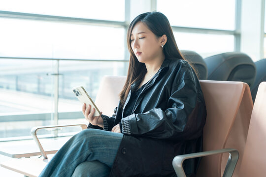 Woman using smartphone at airport